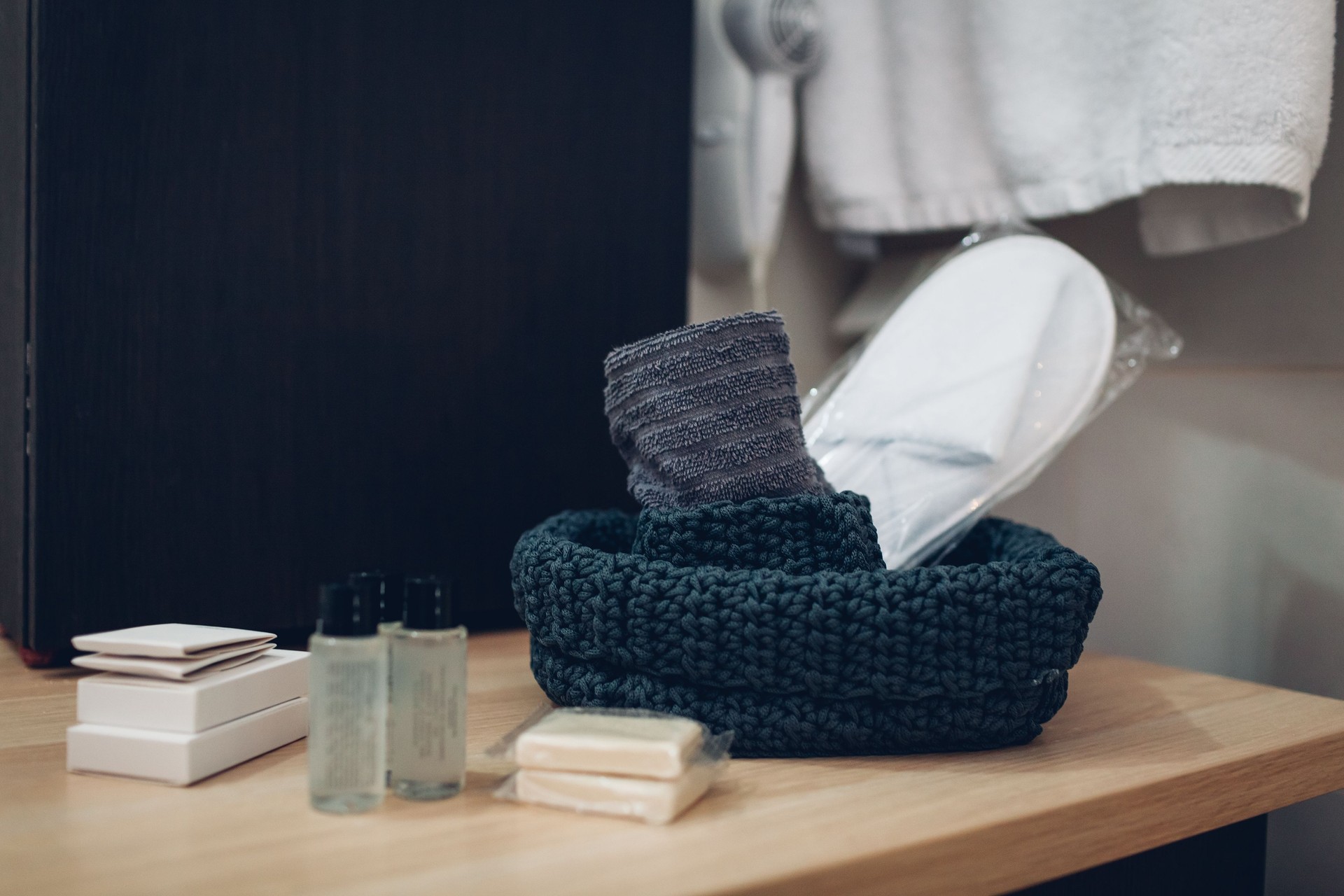 Hotel bathroom personal cosmetics and products. Slippers, soap, towels, shampoo and shower gel